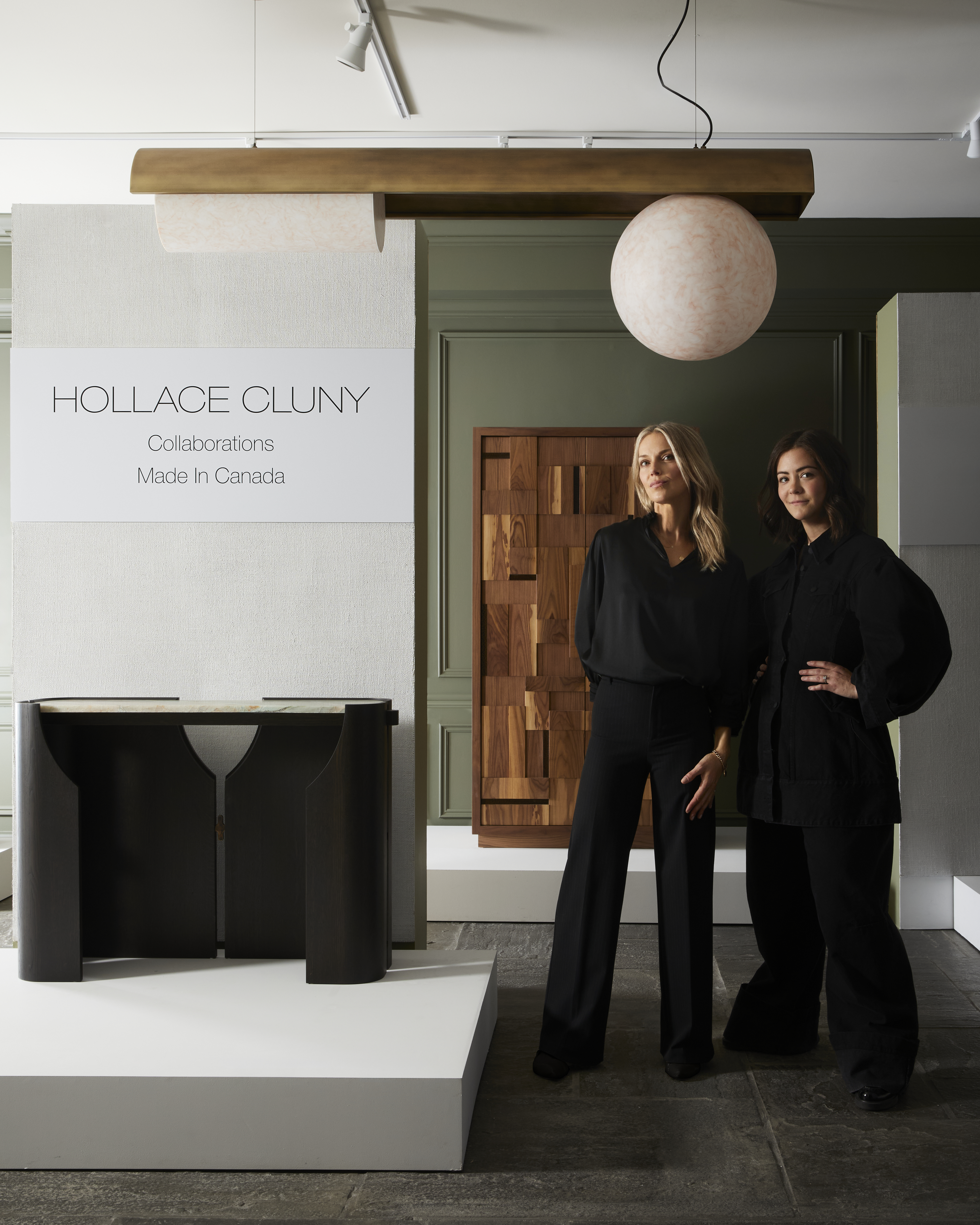 Kim Lambert Interior Designer and Clarisa Llaneza Interior Designer standing in front of their furniture collections designed for Hollace Cluny 